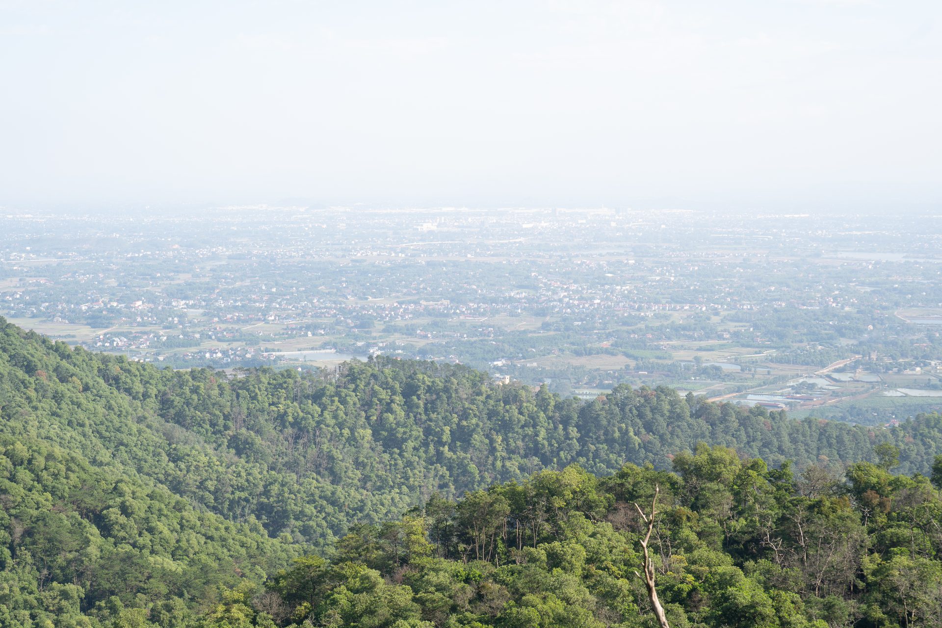 A hazy panorama of Sóc Sơn seen from the mountain