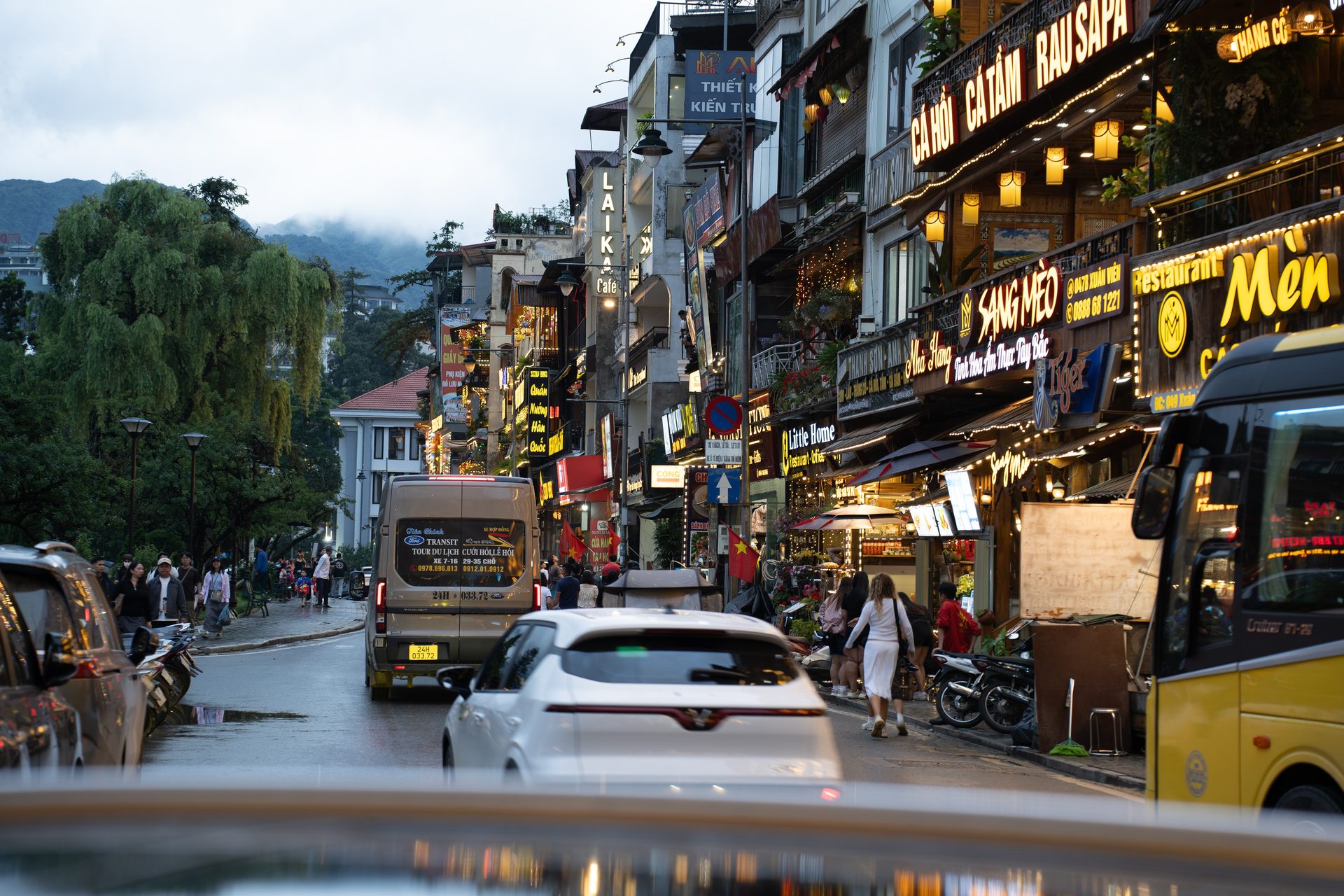 Sa Pa at dusk, where restaurant lights and evening traffic fill a mountain street