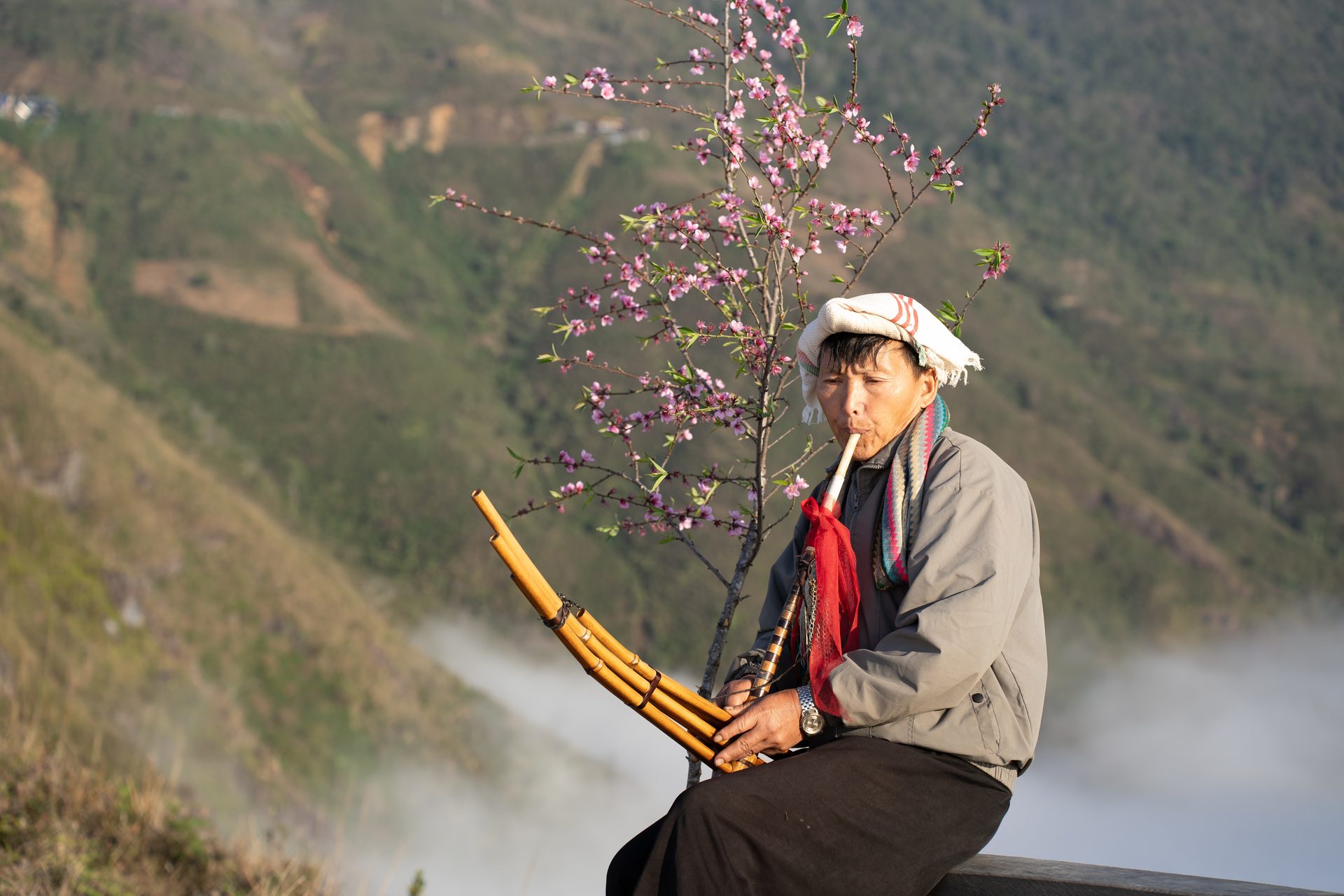 A local musician performs with a traditional instrument on the Dinosaur Spine