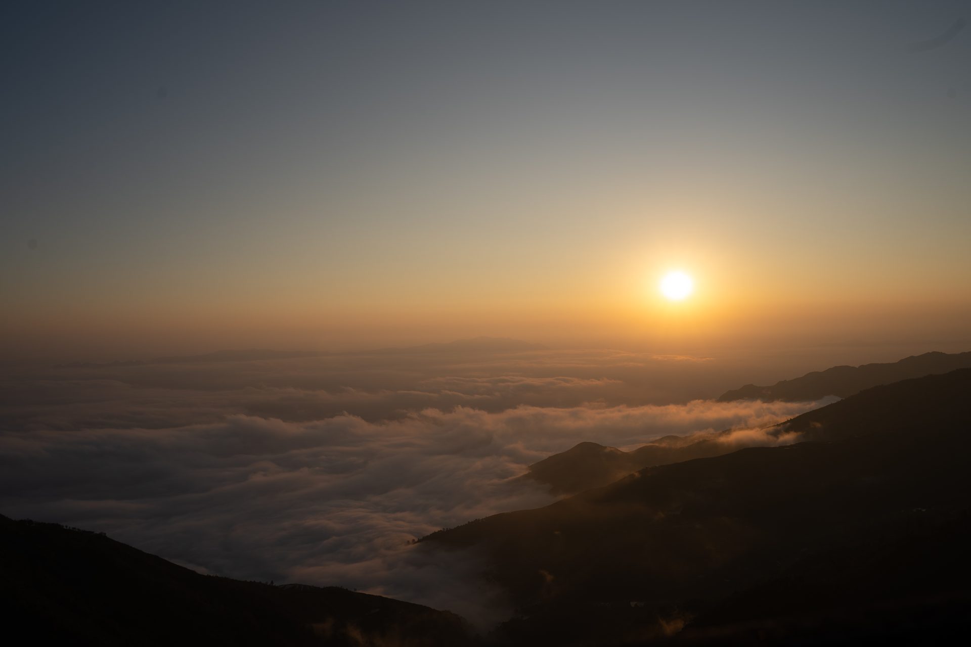 Sunset over Khe Gió, with layered mountains fading into the evening haze